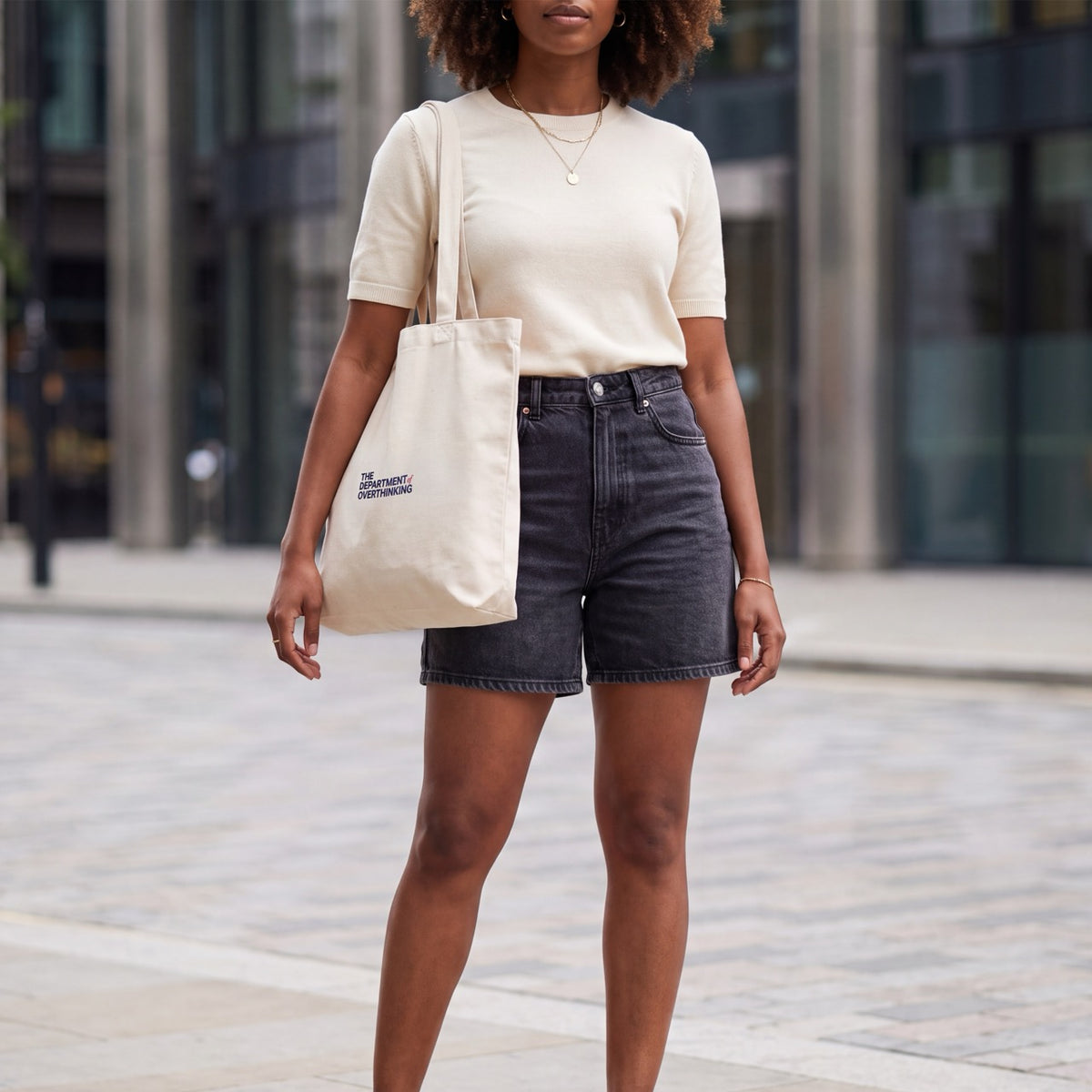 Woman wearing a Natural Raw Department of Overthinking tote bag over her shoulder
