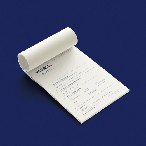 PAUSED. A5 tear-off overthinking notepad displayed open on a navy background