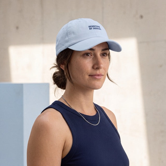 Woman wearing a light blue Department of Overthinking embroidered baseball cap