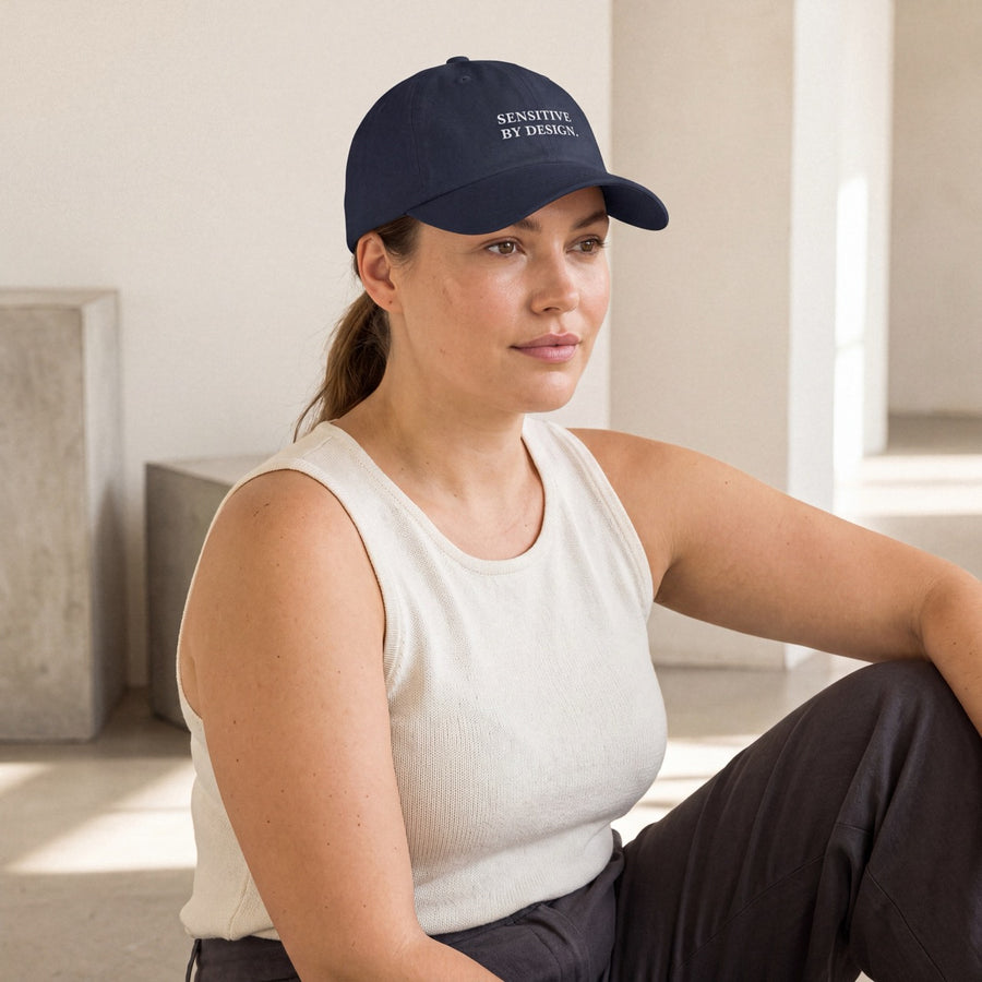 Woman wearing a navy Department of Overthinking embroidered baseball cap