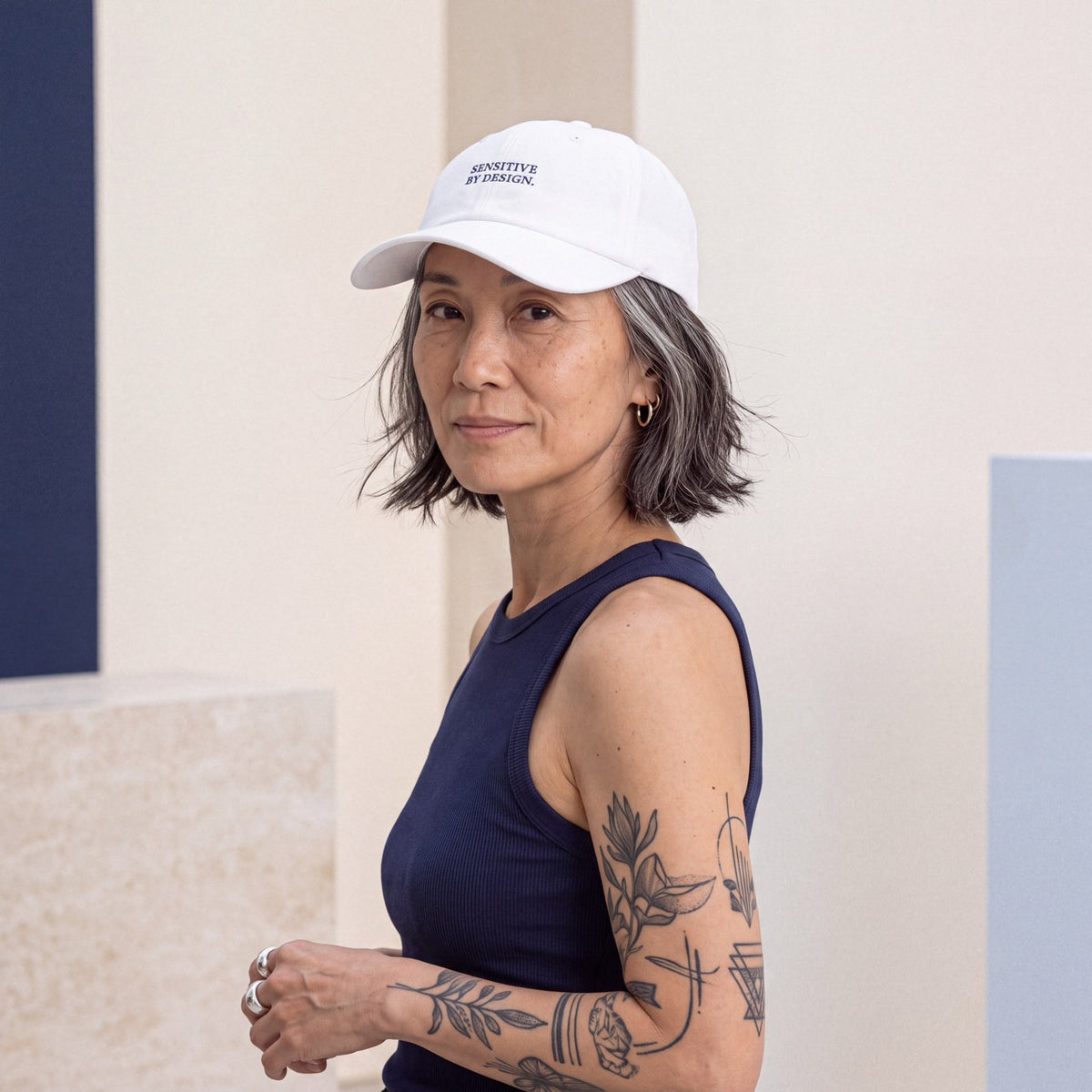 Woman wearing a white Department of Overthinking embroidered baseball cap