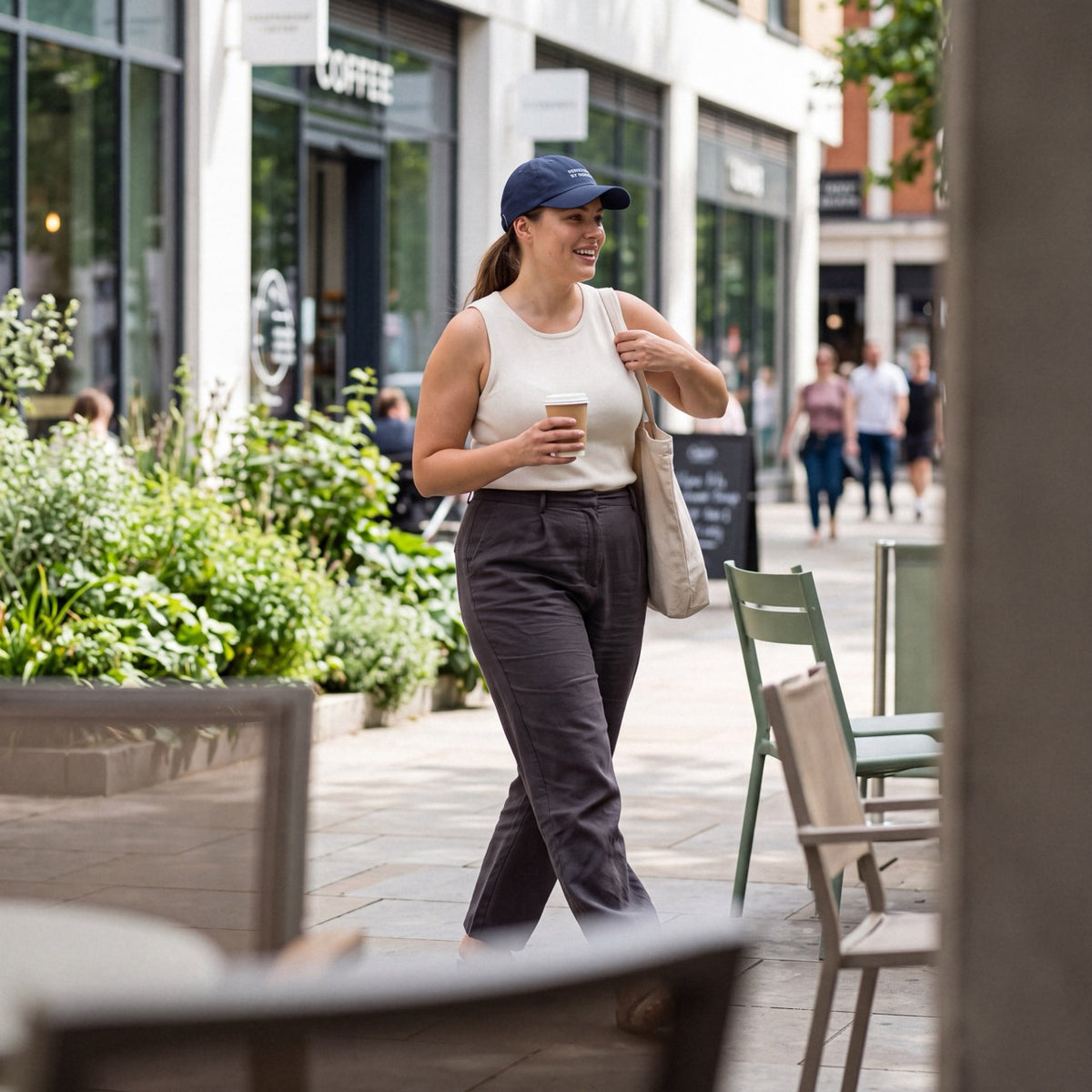 Woman wearing a navy Department of Overthinking cap outdoors