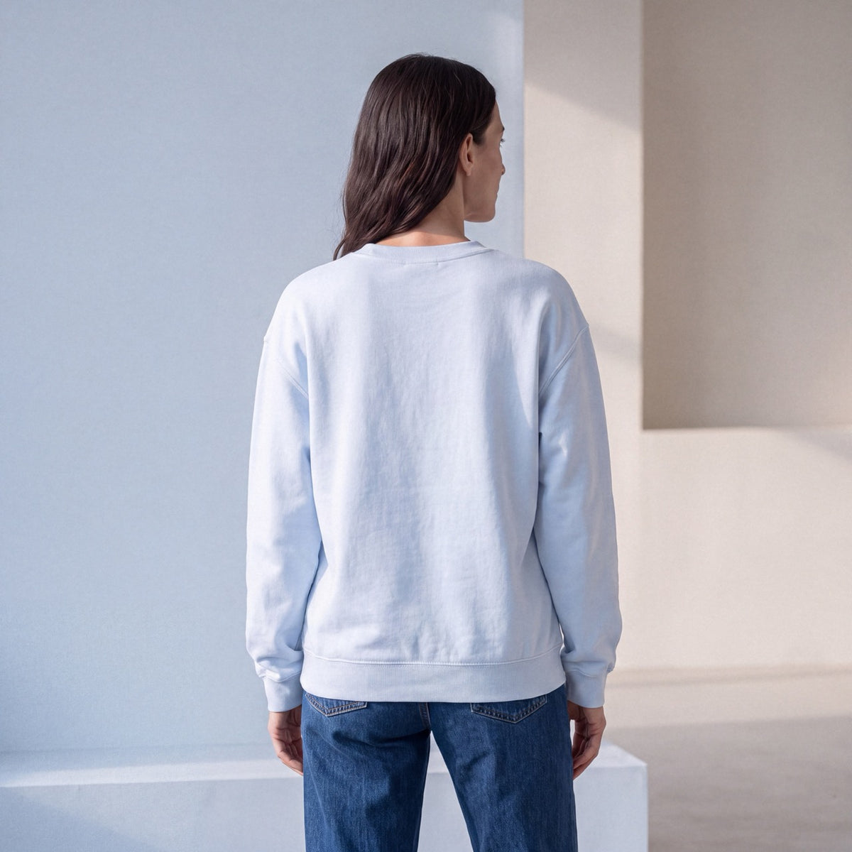 Back view of light blue SENSITIVE BY DESIGN. crewneck sweatshirt