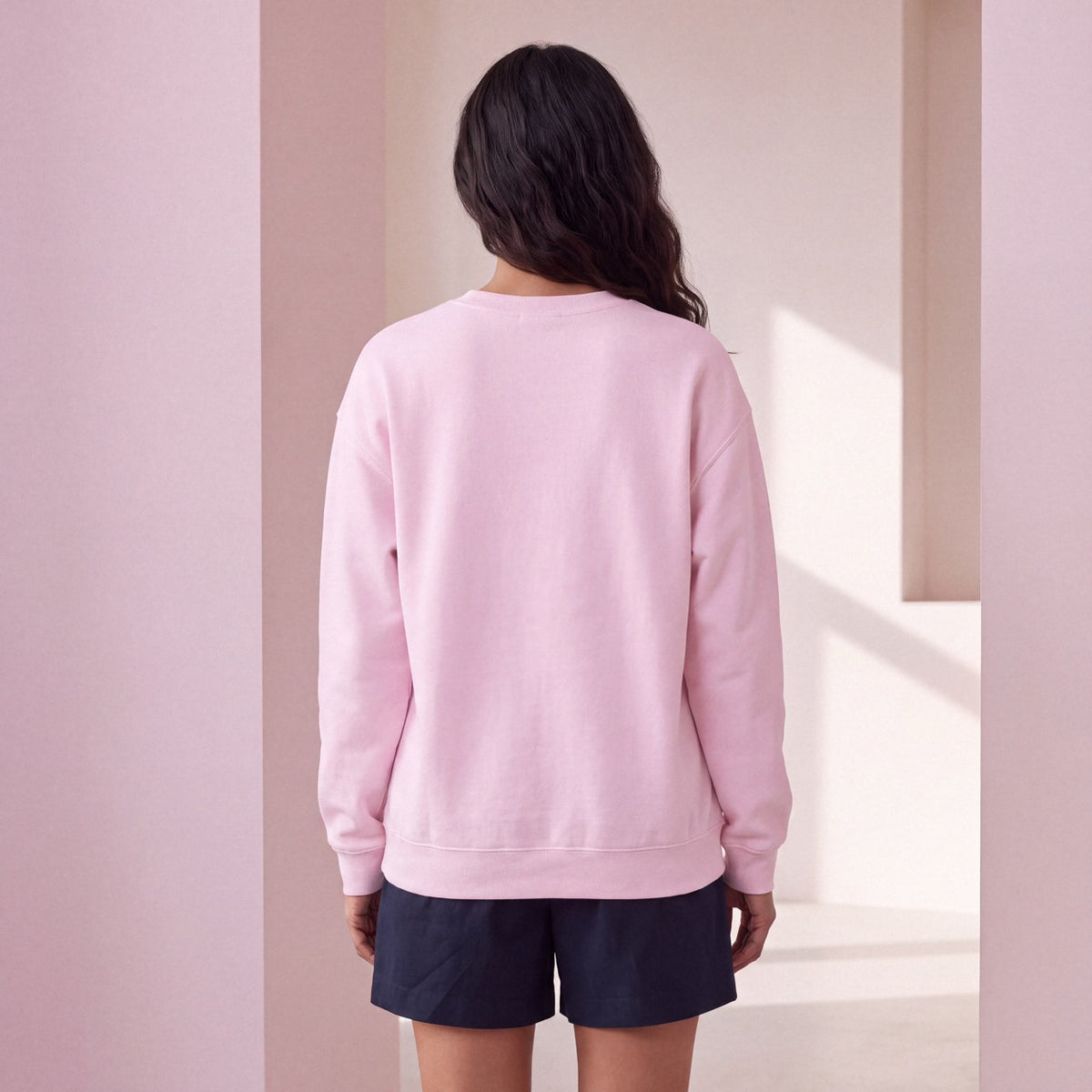 Back view of light pink SENSITIVE BY DESIGN. crewneck sweatshirt