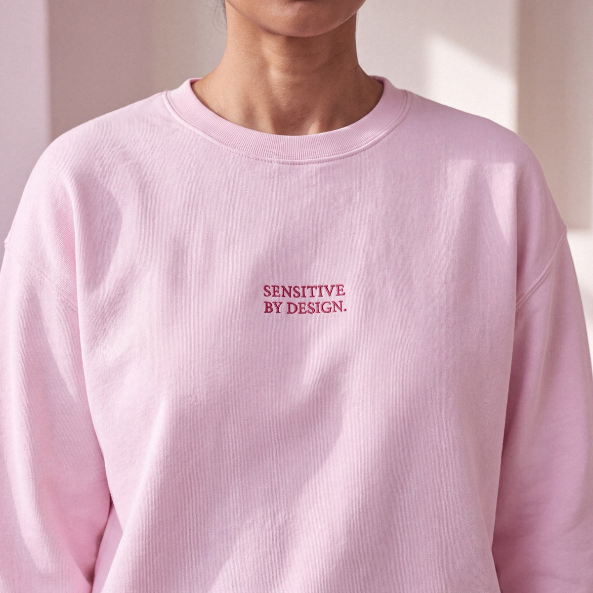 Close-up of light pink Department of Overthinking embroidered sweatshirt